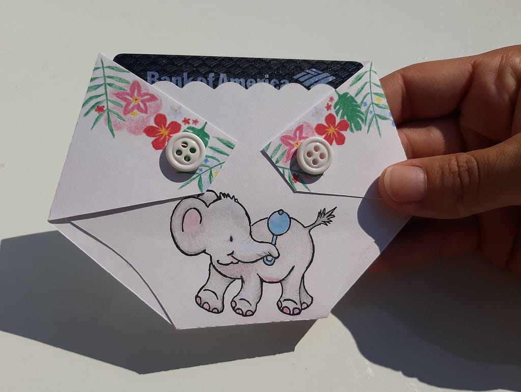 diaper shaped gift card holder with an elephant holding a rattle