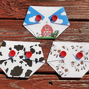 three diaper shaped gift card holders with farm and cow prints