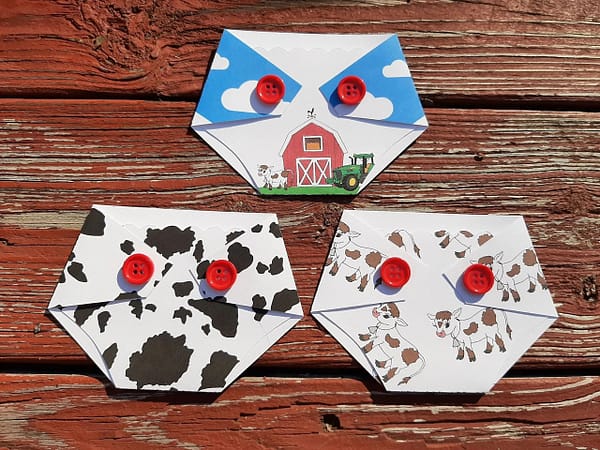 three diaper shaped gift card holders with farm and cow prints