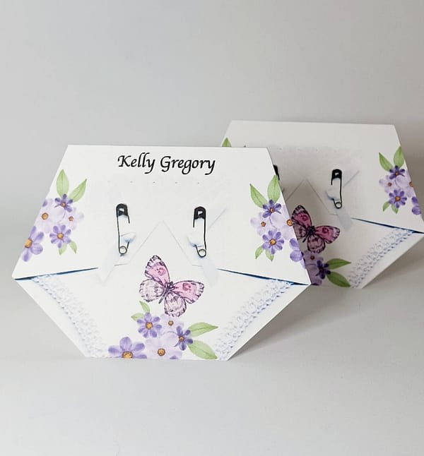 diaper shaped place card with a pink and purple butterfly print