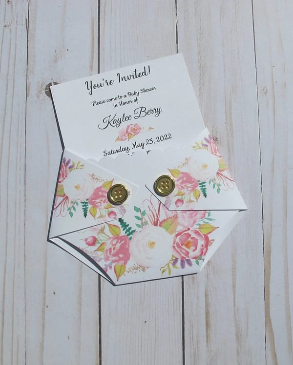 floral patterned diaper shaped baby shower invitation with insert pilled out the top
