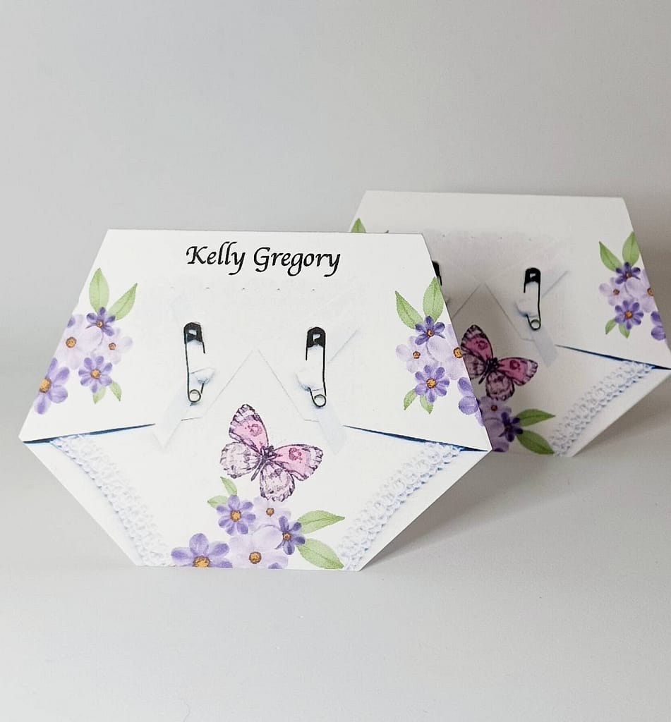diaper shaped baby shower place card with a pink and purple butterfly print